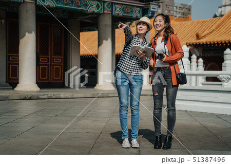 ladies showing chinese garden view in temple. 51387496