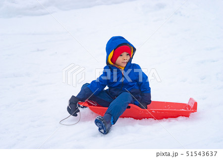 Little Japanese boy is sliding down the snow sled Little Japanese boy is sliding down the snow sled 51543637
