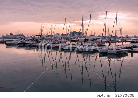 Pink sunset in the sea harbor with moored yachts. Pink sunset in the sea harbor with moored yachts. 51580009