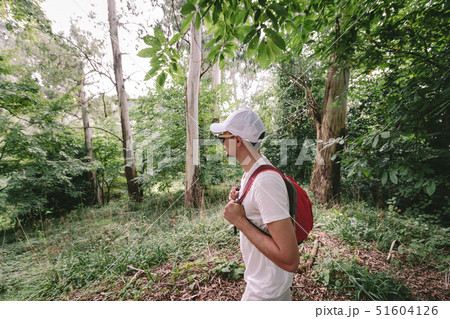man with backpack walking in the forest 51604126
