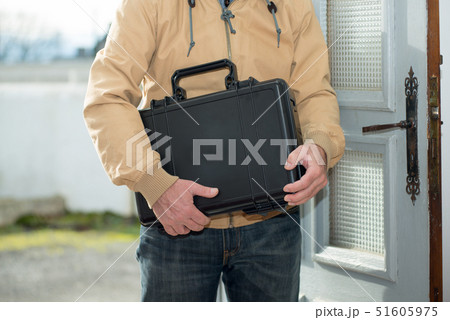 man with a black suitcase going home 51605975