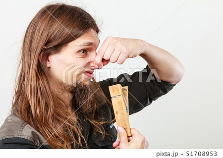 Man with clogged nose by clothespin 51708953