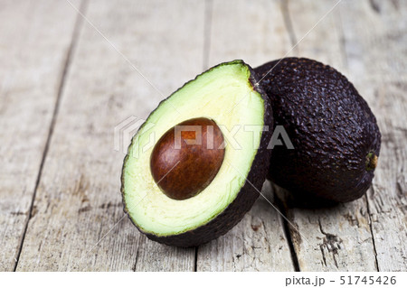 Fresh organic avocado halves on old wooden table 51745426