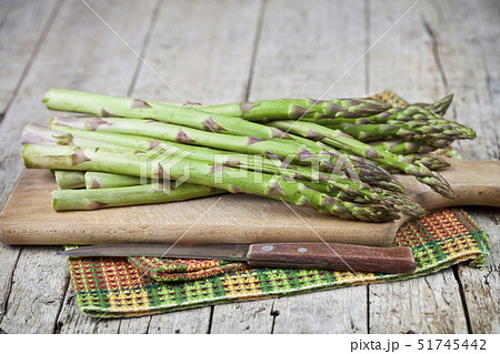 Organic raw garden asparagus and knife closeup on 51745442