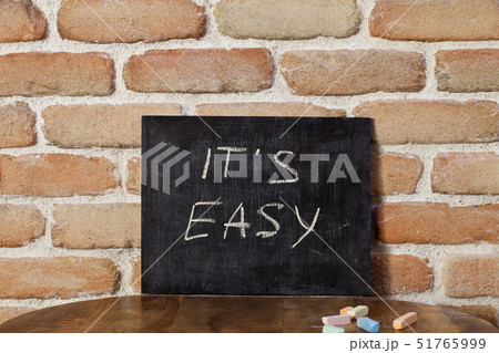 Black board with the phrase IT'S EASY drown by 51765999