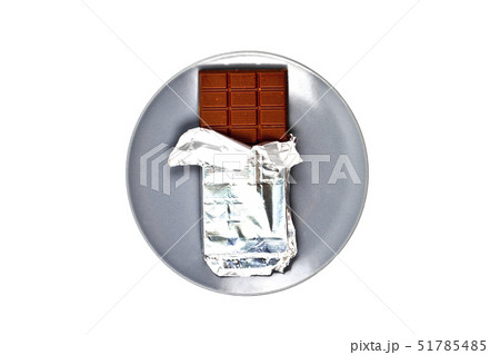 Chocolate bar with foil on grey ceramic plate Chocolate bar with foil on grey ceramic plate 51785485