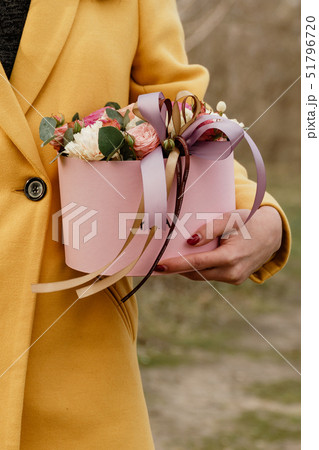 Beautiful woman holding pink box with flowers. Gift to Women's Day. Agency floral design, place text Beautiful woman holding pink box with flowers. Gift to Women's Day. Agency floral design, place text 51796720