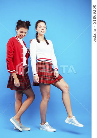 best friends teenage school girls together smiling having fun, posing emotional on blue background 51869200