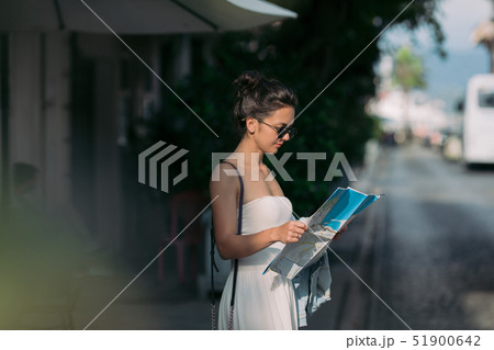 tourist woman looking at the map on the street 51900642
