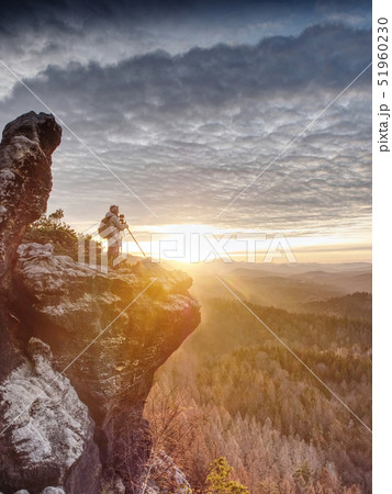 Woman hiker set tripod with camera on exposed 51960230