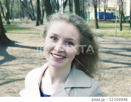 young pretty blonde girl enjoing spring nature in park, lifestyle people concept close up young pretty blonde girl enjoing spring nature in park, lifestyle people concept close up 52100946