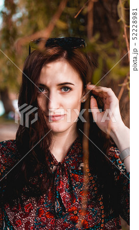 Beautiful young woman in burgundy leaves 52228981