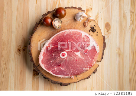 Piece of raw pork ham cut on wooden cutting board 52281195