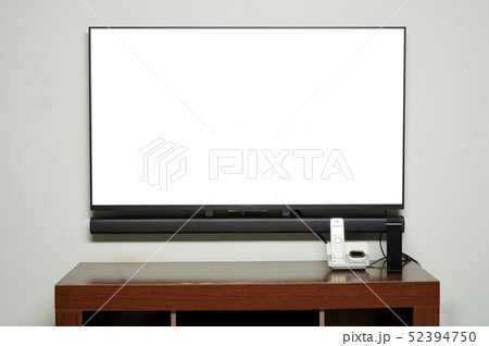 Table in living room with TV and phone Table in living room with TV and phone 52394750