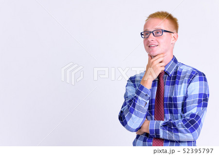Happy young blonde businessman with eyeglasses thinking Happy young blonde businessman with eyeglasses thinking 52395797