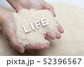 woman's hands holding jasmine rice 52396567