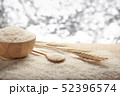 Jasmine rice in a wooden bowl and wooden spoon 52396574