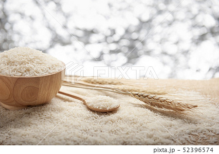 Jasmine rice in a wooden bowl and wooden spoon 52396574
