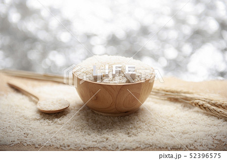 Jasmine rice in a wooden bowl with LIFE 3D text 52396575
