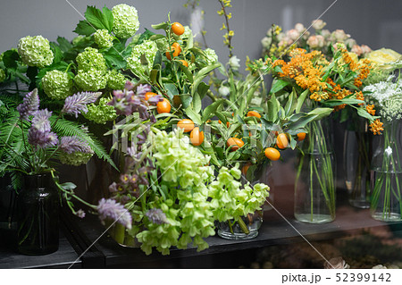 Flower shop concept. Glass vases with different colors on the shelves of the refrigerator showcases Flower shop concept. Glass vases with different colors on the shelves of the refrigerator showcases 52399142
