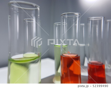 Pipettes take samples to a test tube containing ch 52399490