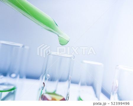Pipettes take samples to a test tube containing ch 52399496