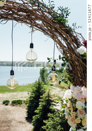 beautiful arch for the wedding ceremony in the park with white chairs for guests 52411677