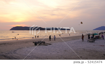KEDAH, LANGKAWI, MALAYSIA - APR 08th, 2015: Tourists having romantic moment during sunset at Cenang KEDAH, LANGKAWI, MALAYSIA - APR 08th, 2015: Tourists having romantic moment during sunset at Cenang 52415474
