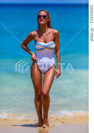 Sexy woman in white bikini walking at Karon beach, 52433005
