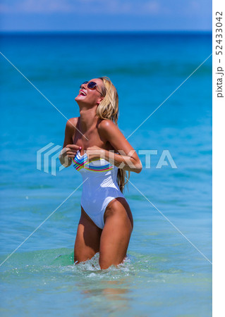 Sexy woman in white bikini walking at Karon beach, 52433042