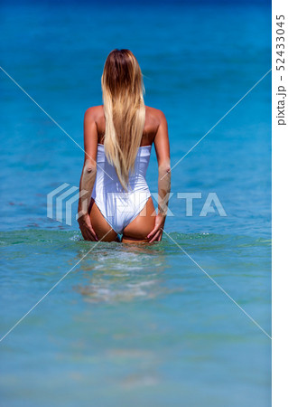 Sexy woman in white bikini walking at Karon beach, 52433045