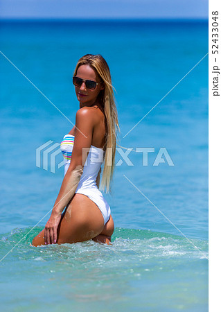 Sexy woman in white bikini walking at Karon beach, 52433048