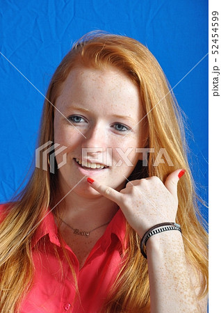 Teen miming a phone with her hand 52454599