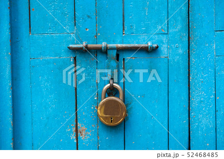 Golden padlock with blue door Golden padlock with blue door 52468485