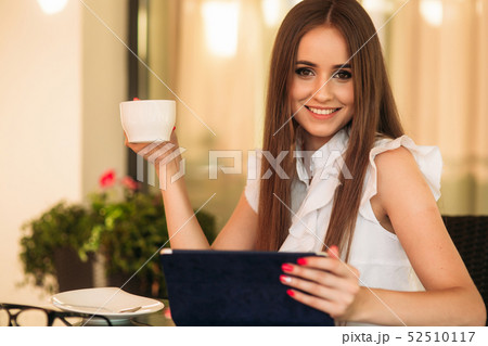 Young beautiful girl use a laptop during a break at work. Summer 52510117
