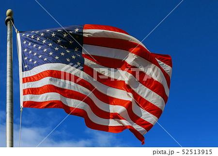 Slight Motion blur American flag against a blue 52513915