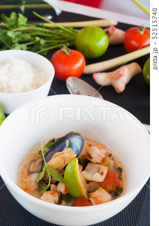 Seafood Thai soup served on white bowl, Thai food cuisine calling Tom Yum Kung. Seafood Thai soup served on white bowl, Thai food cuisine calling Tom Yum Kung. 52515740