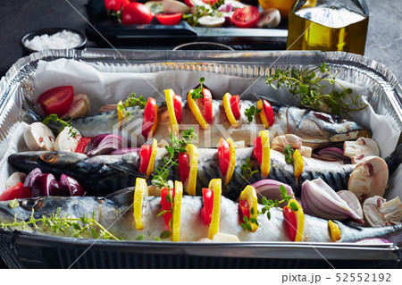 three raw mackerel in a baking pan, close up three raw mackerel in a baking pan, close up 52552192