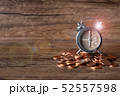 Alarm clock at six o' clock on pill of gold coins  52557598