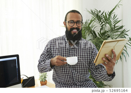 Casual businessman with tablet pc at office Casual businessman with tablet pc at office 52695164