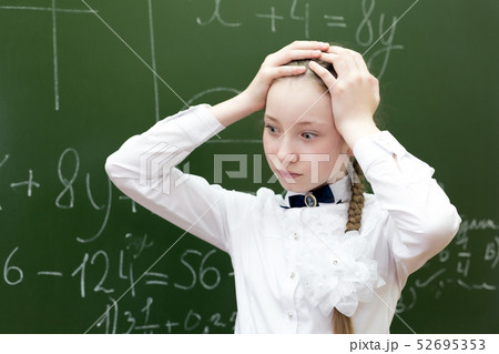 The schoolgirl grabbed her head from the tension. The schoolgirl grabbed her head from the tension. 52695353