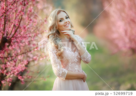 Portrait of blonde in the garden. makeup, Airy dress Portrait of blonde in the garden. makeup, Airy dress 52699719
