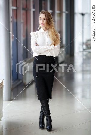 A woman in a business suit. Long hair and red lips A woman in a business suit. Long hair and red lips 52703285