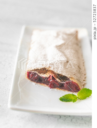 Cherry strudel on the white plate 52723837