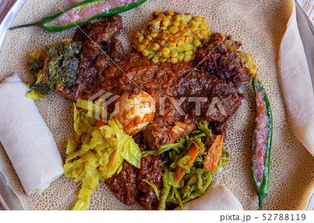 Injera with an assortment of toppings Injera with an assortment of toppings 52788119