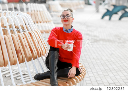 Smiling woman with a cup of coffee - Stock image 52802285