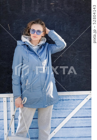 Young beautiful blonde girl walking through the city streets 52804143