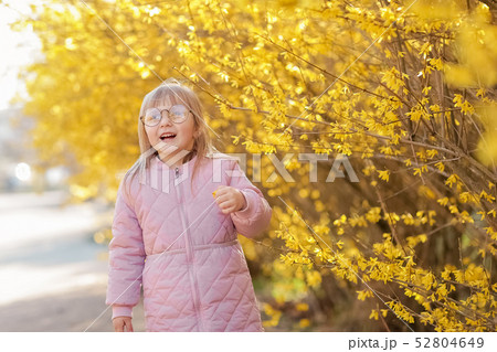 Stylish child girl 5-6 year old wearing trendy pink coat in autumn park. Looking at camera. Autumn Stylish child girl 5-6 year old wearing trendy pink coat in autumn park. Looking at camera. Autumn 52804649