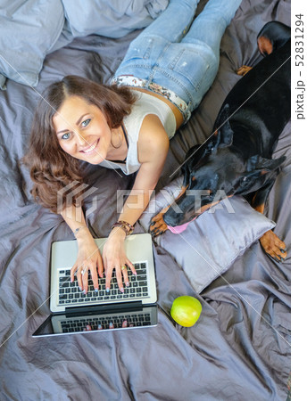 Woman in bed with big dog 52831294