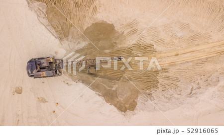Aerial top down view of excavator working in quarry or construction site. 52916065